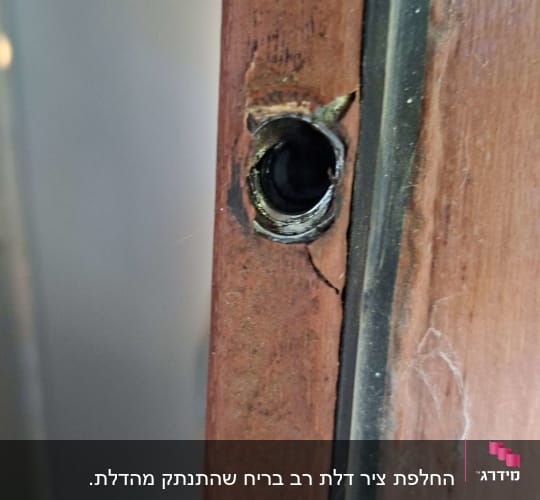 חור בדלת עץ עם סימני תיקון